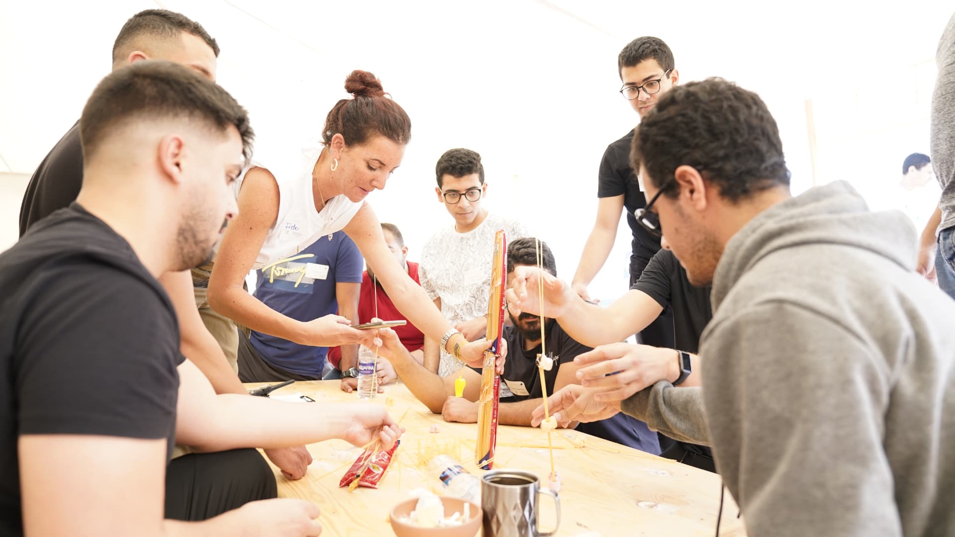A team collaborating on a hands-on building challenge indoors