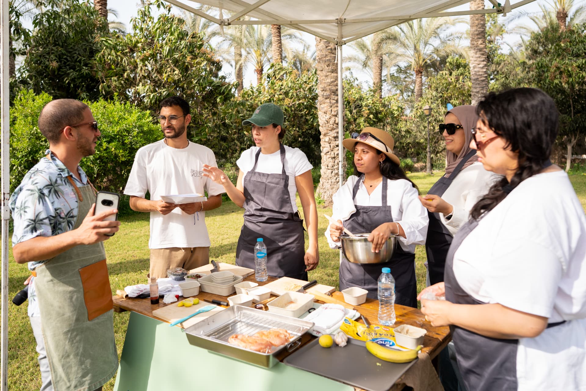 Colleagues cooking together outdoors during a team activity